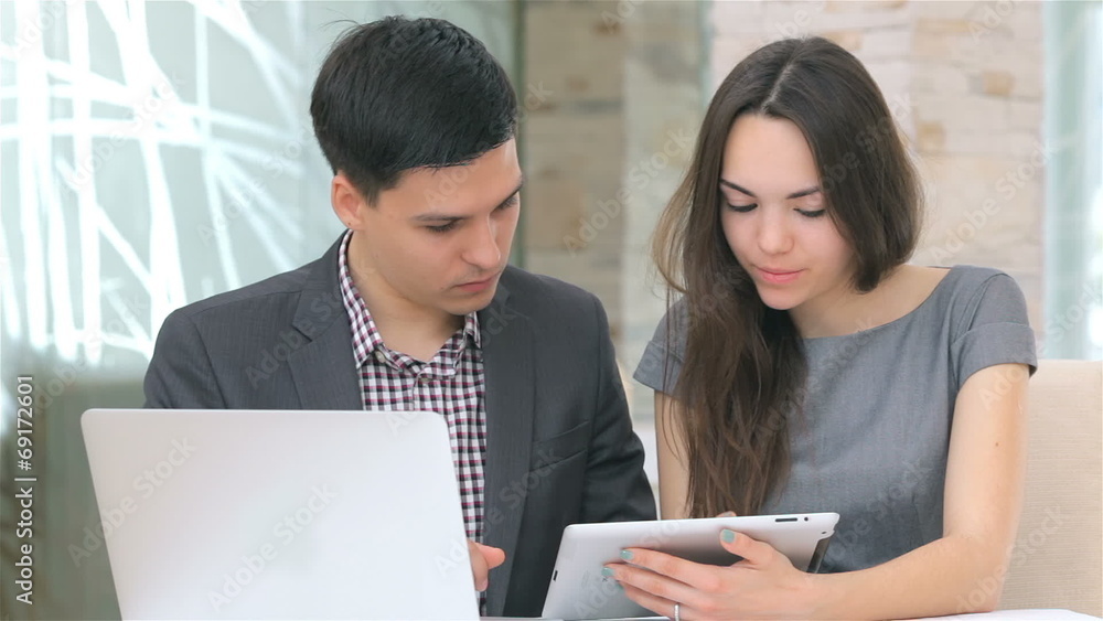 young attractive business man and woman discussing collating young attractive business man and woman discussing collating