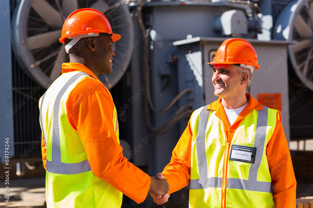 power company co-workers hand shaking power company co-workers hand shaking