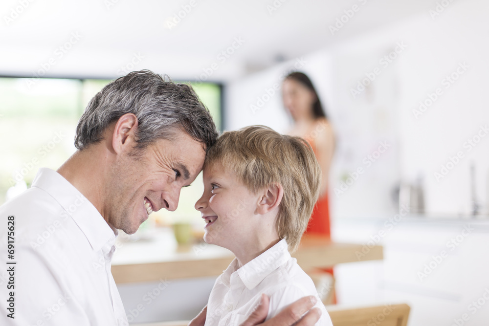 portrait of a father and his little boy indoors portrait of a father and his little boy indoors