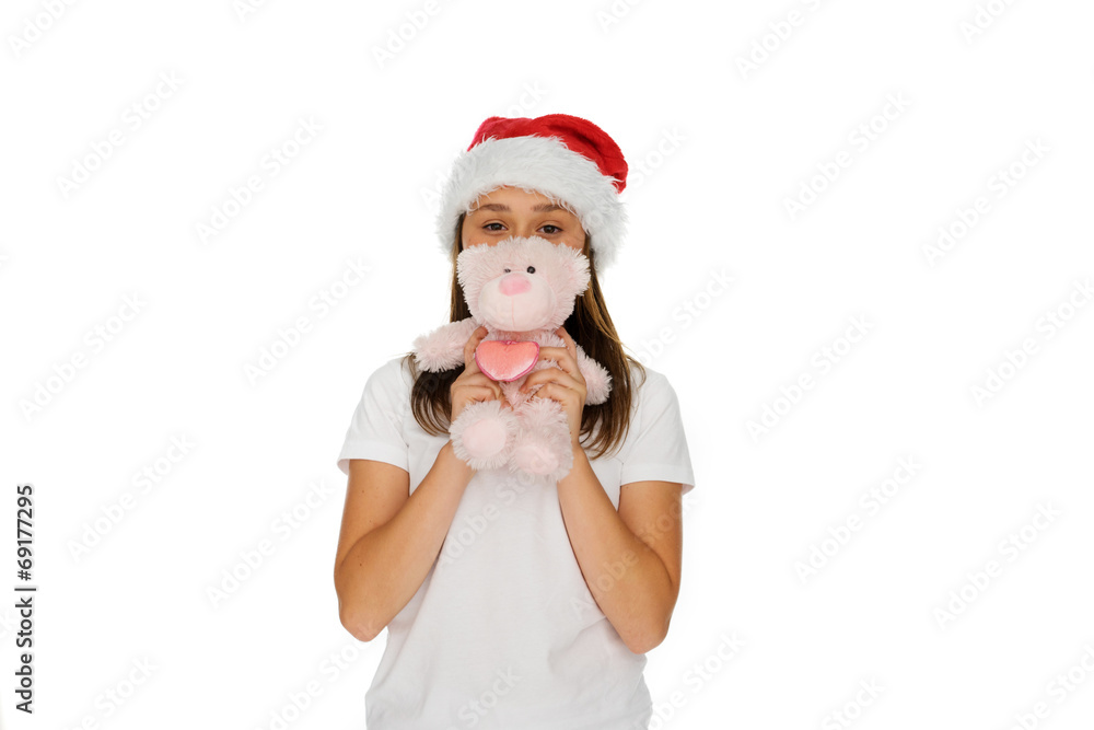 Young girl in a Santa hat with a teddy bear Young girl in a Santa hat with a teddy bear