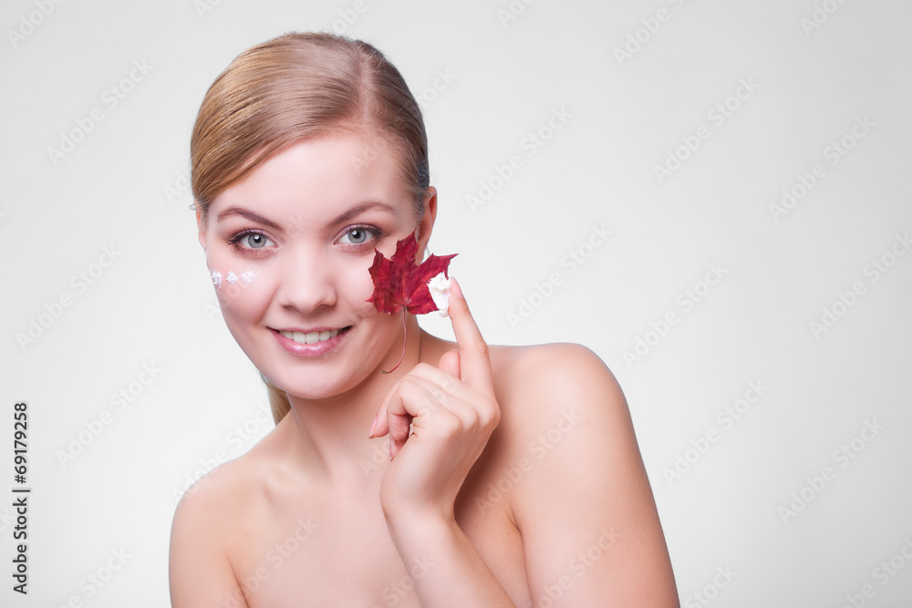 Skin care. Face of young woman girl with red maple leaf. Skin care. Face of young woman girl with red maple leaf.
