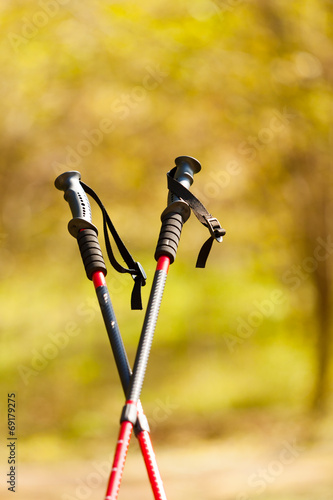 Fotografie Nordic walking. Red sticks in park or forest