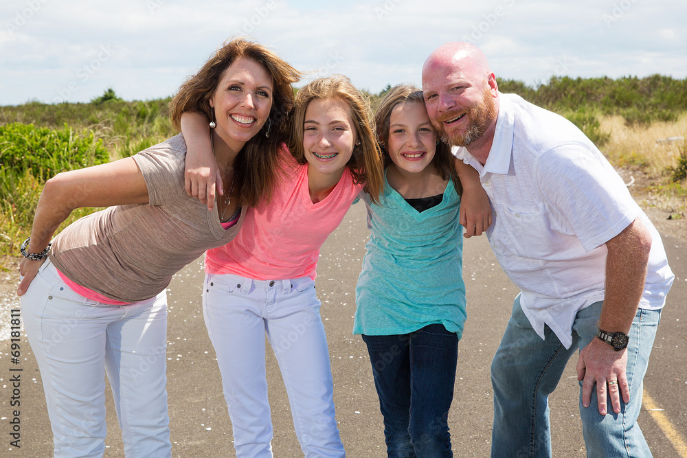 A happy family huddles together with happy smiles A happy family huddles together with happy smiles