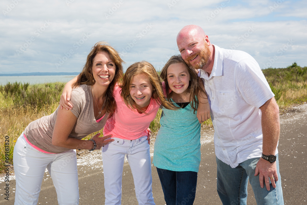 A happy family huddles together with happy smiles A happy family huddles together with happy smiles