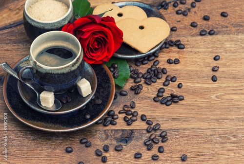Cup of black coffee with red rose flower and heart cake © LiliGraphie