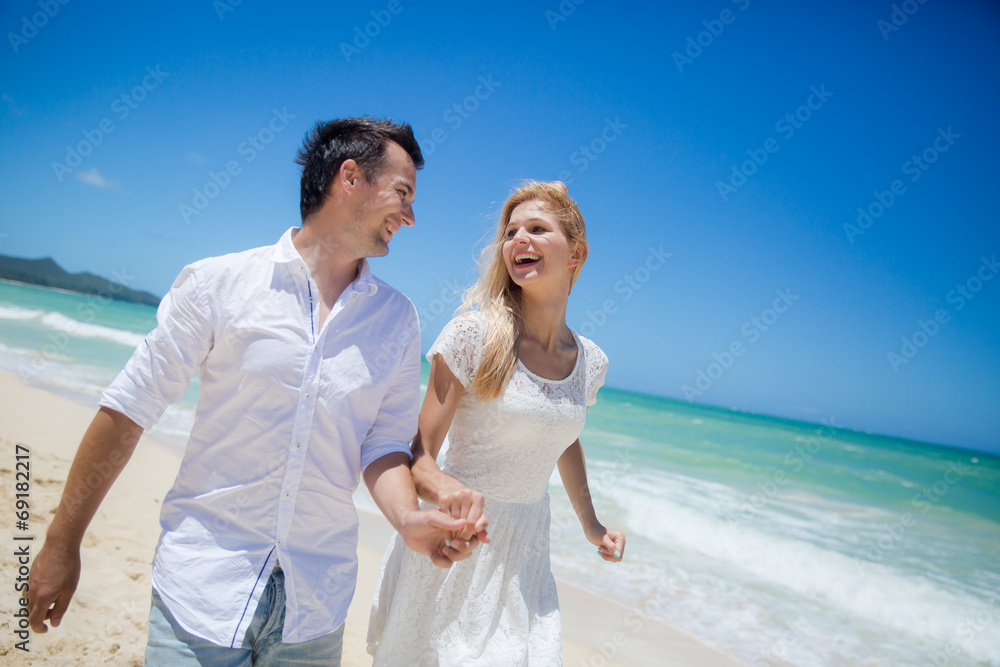 Couple running on a sandy beach