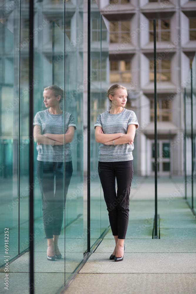 Young business woman in modern glass interior