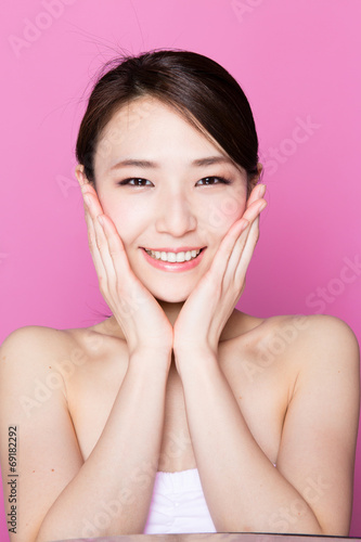 attractive asian woman on pink background