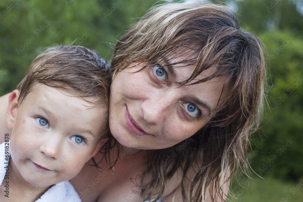 Portrait of happy mother and her little son after bathing. Portrait of happy mother and her little son after bathing.