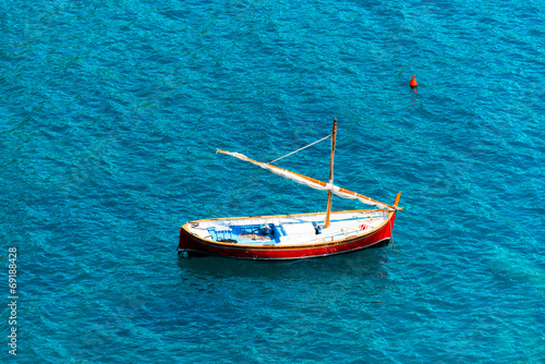 Small Wooden Sailboat at Sea