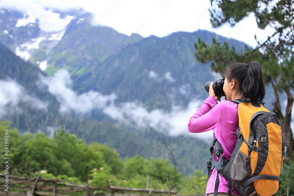 young woman photographer taking photo outdoor