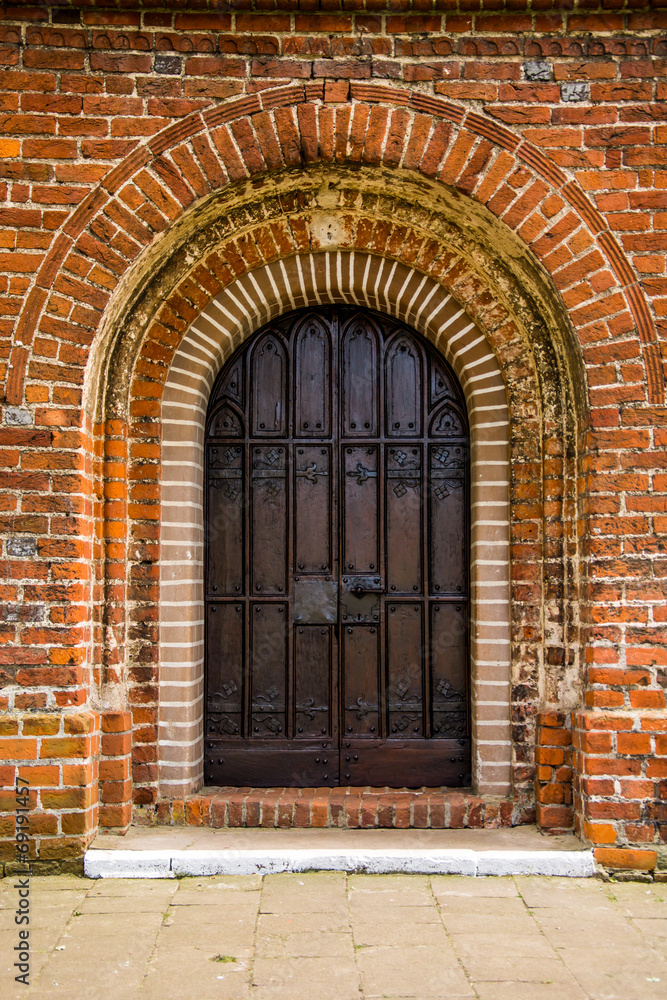 old door of medieval Cistercian monastery in Kolbacz, Poland