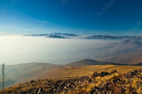 Mountain landscape with fog over the valley