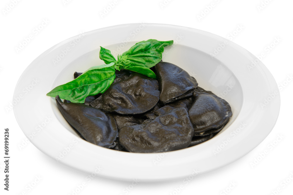 black dumplings on a plate black dumplings on a plate