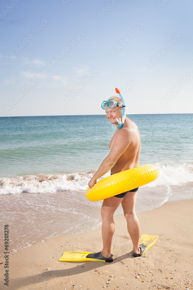 man in flippers and mask on the bank of the sea man in flippers and mask on the bank of the sea