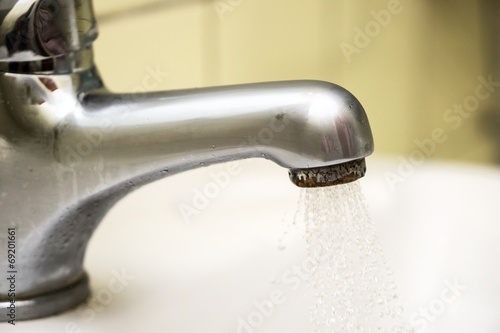 Close up of water coming out of a tap in a spray