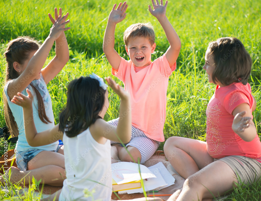 Fototapeta premium Group of children playing on grass