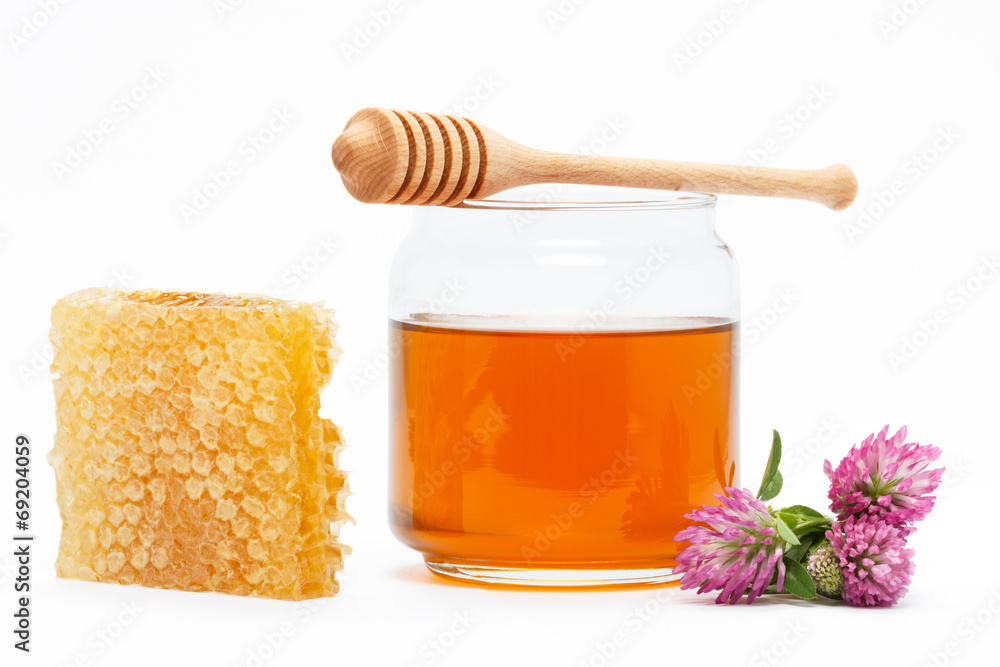 Honey in jar with dipper, honeycomb, flower on isolated backgrou Honey in jar with dipper, honeycomb, flower on isolated backgrou