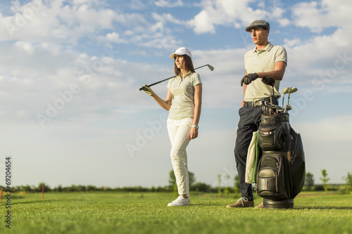 Young couple at golf cart