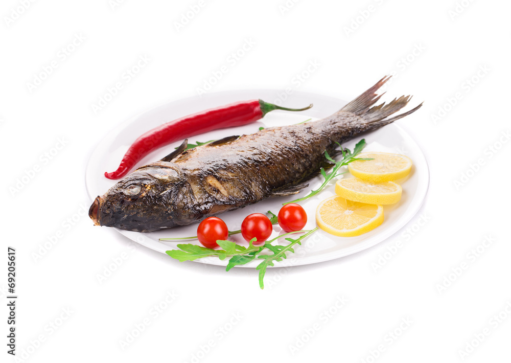 Grilled carp with vegetables on plate. Grilled carp with vegetables on plate.