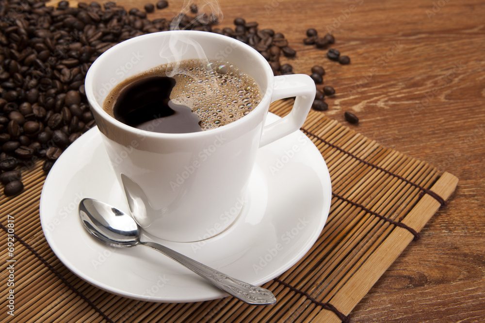 cup of black coffee with roasted coffe beans cup of black coffee with roasted coffe beans