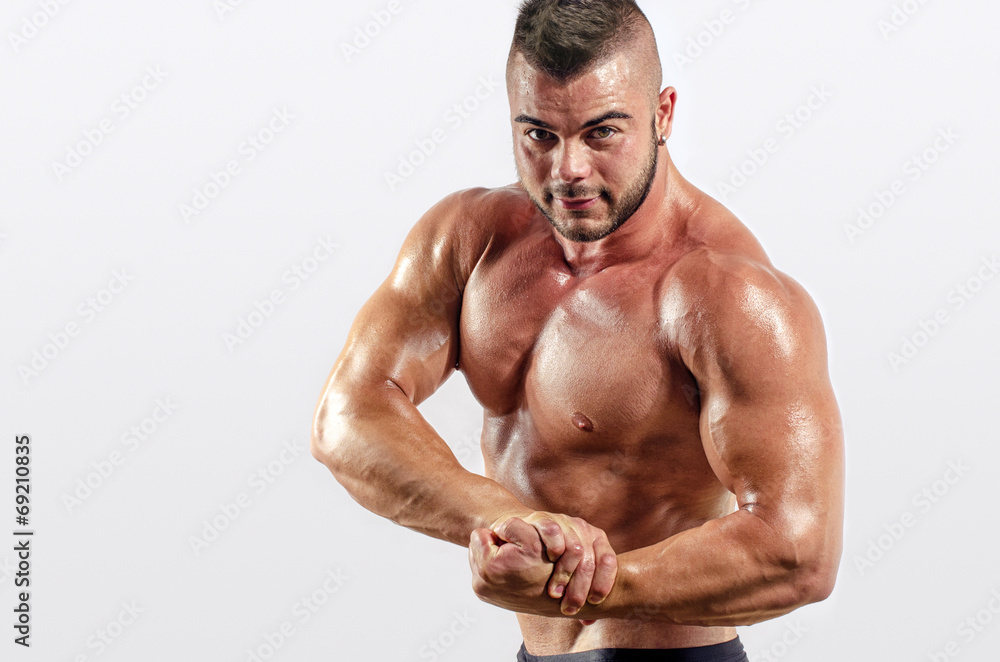 Strong bodybuilder with perfect abs, shoulders,biceps, triceps Strong bodybuilder with perfect abs, shoulders,biceps, triceps