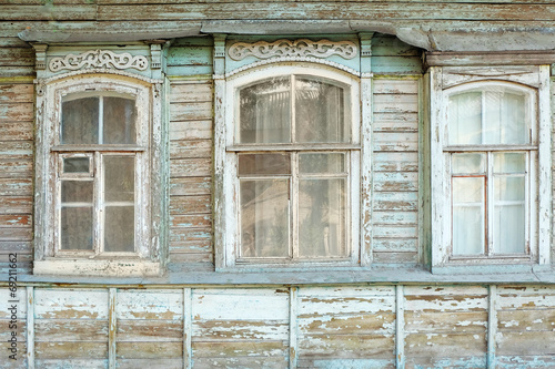 Old windows of obsolete wooden traditional Russian house.