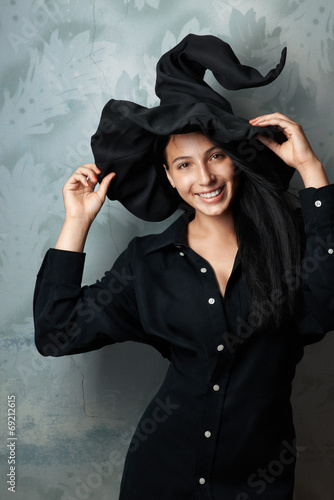 cheerful girl in witch costume smiling Fototapeta