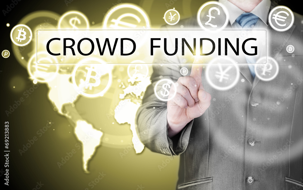 Businessman pushes virtual crowd funding button Businessman pushes virtual crowd funding button