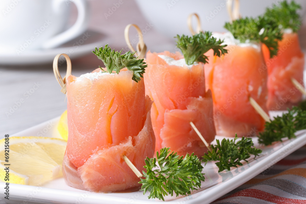 Rolls of red fish with cream cheese close-up horizontal Rolls of red fish with cream cheese close-up horizontal