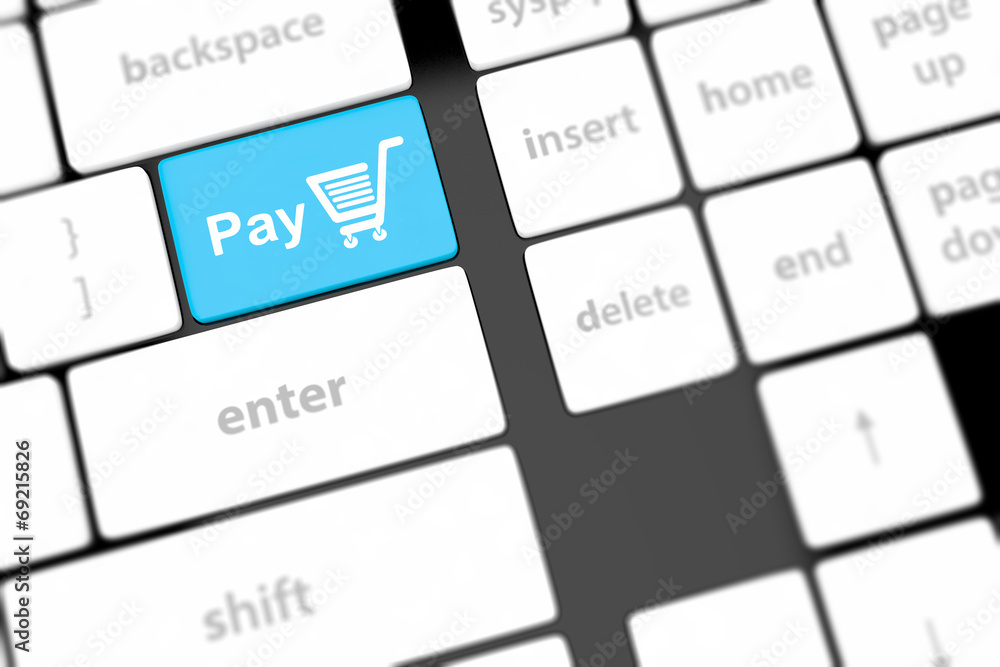Pay key with shopping cart icon on a white keyboard Pay key with shopping cart icon on a white keyboard