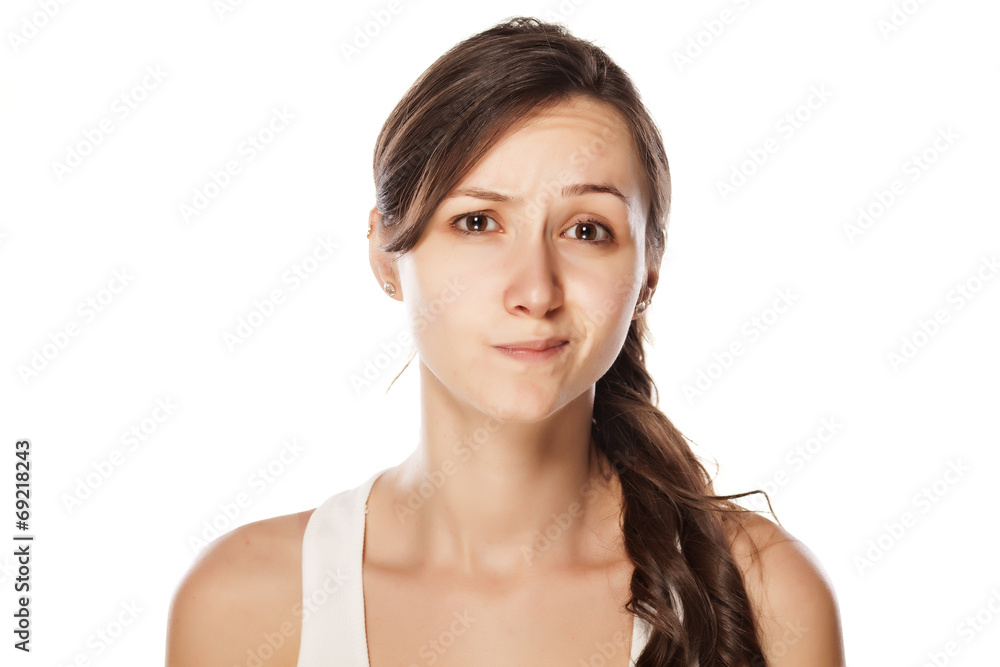 dissatisfied young woman posing on a white background dissatisfied young woman posing on a white background