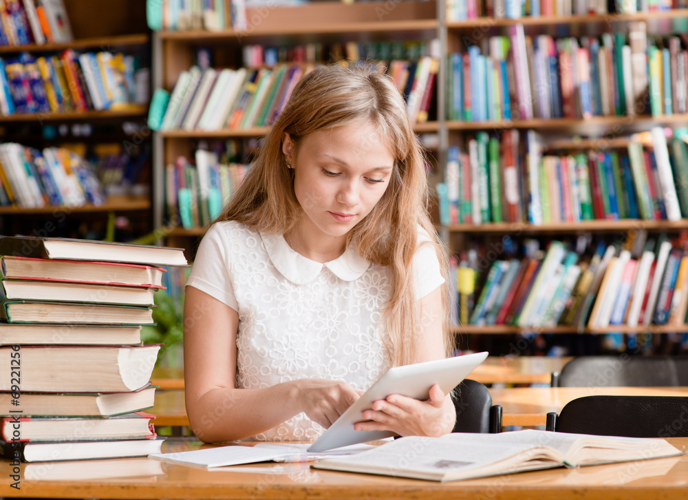 pretty girl with tablet computer working in library pretty girl with tablet computer working in library