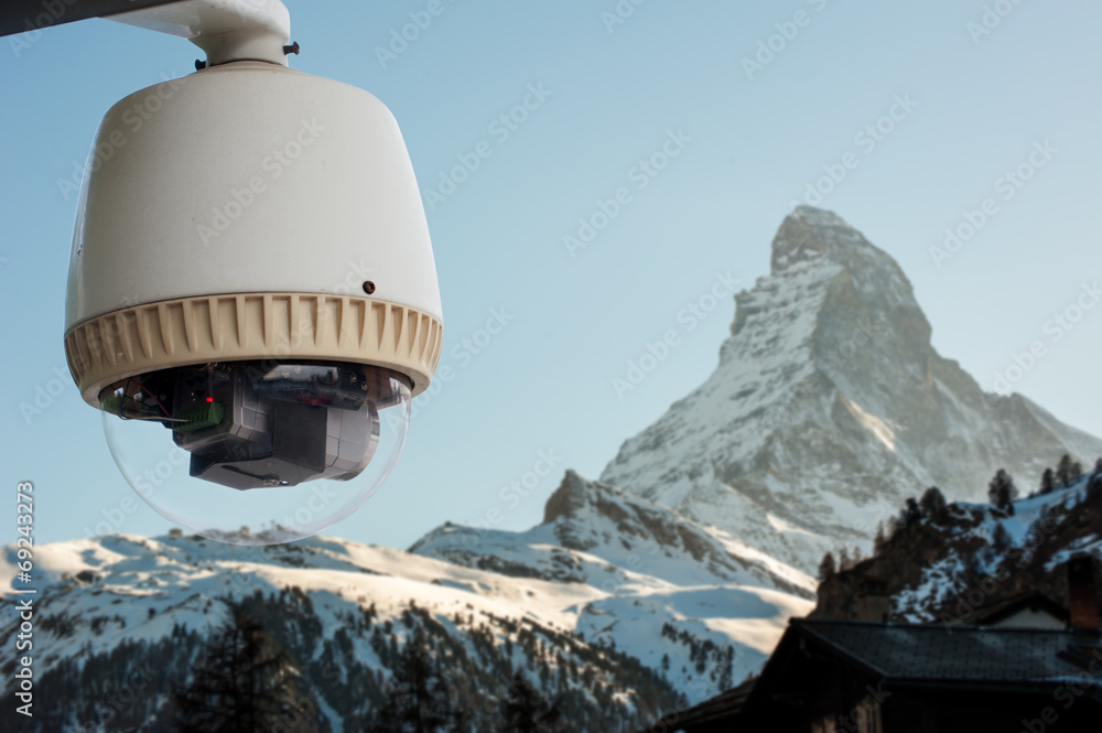 Obraz premium CCTV Camera or surveillance orperating with Matterhorn snow moun