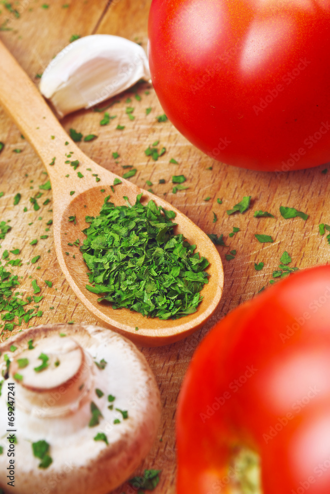 Chopped parsley on wooden spoon Chopped parsley on wooden spoon