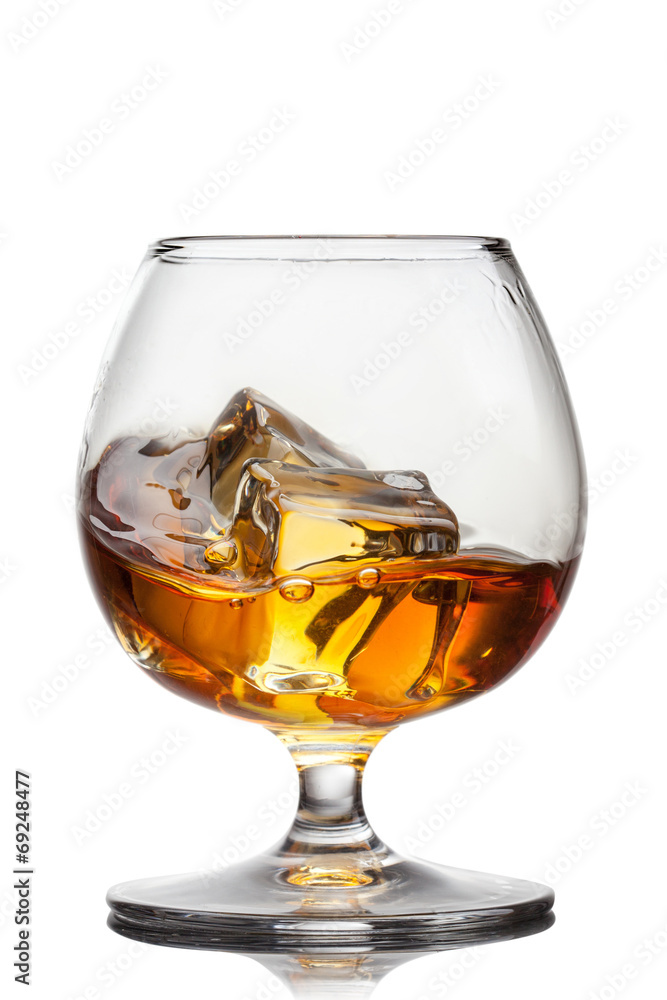 Splash of whiskey with ice in glass isolated Splash of whiskey with ice in glass isolated