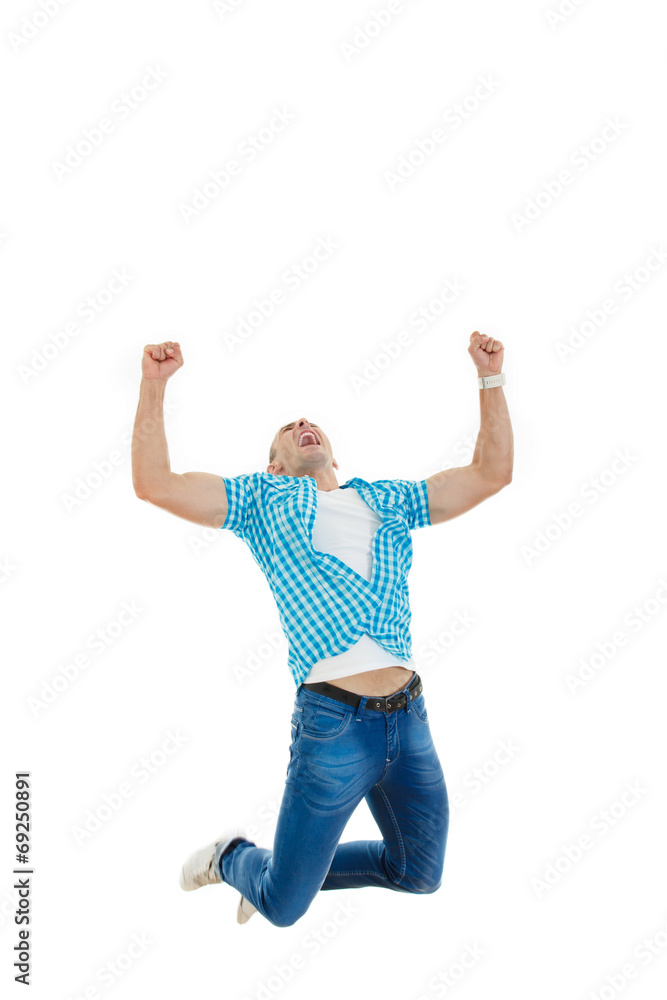 man in blue shirt and jeans jumping in the air with his hands ra man in blue shirt and jeans jumping in the air with his hands ra
