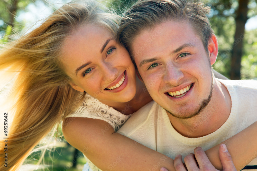 Portrait of a happy couple laughing at camera Portrait of a happy couple laughing at camera