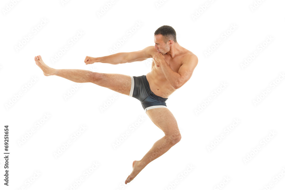 Excellent fight pose of intense man boxer with a kick