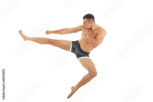 Excellent fight pose of intense man boxer with a kick