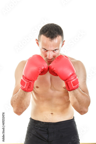 serious muscular man with connected red boxing gloves near his f