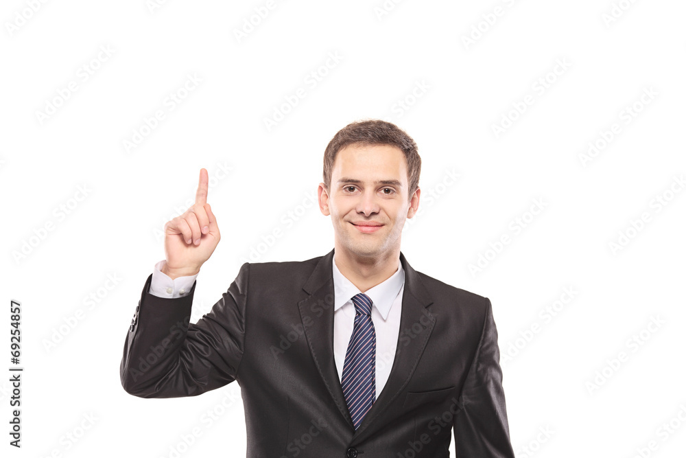 Young businessman pointing up with his finger Young businessman pointing up with his finger