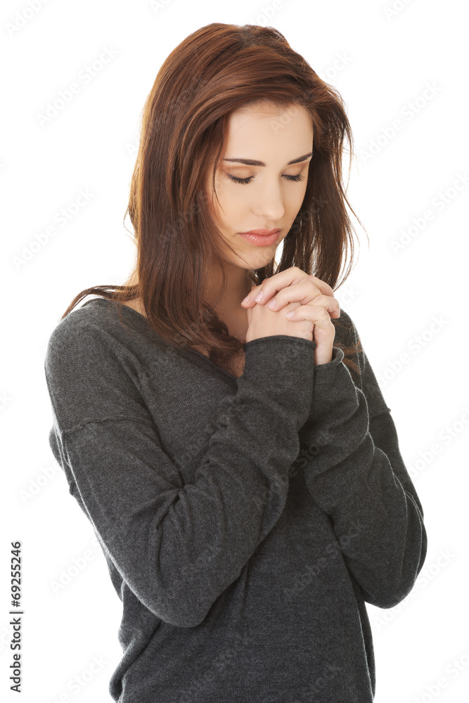 Woman praying with her hands together Woman praying with her hands together
