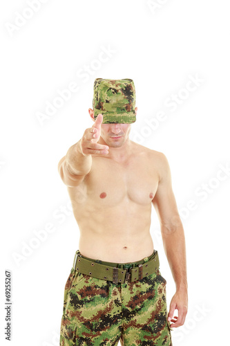 Military soldier in camouflage uniform pointing at camera
