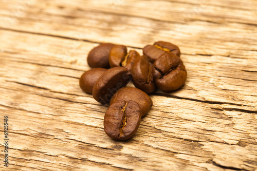 Roasted coffee beans on old wooden table