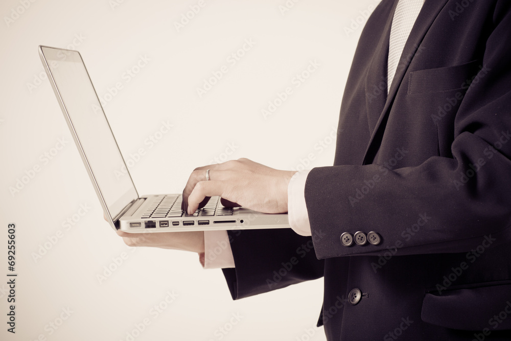 Asian business man using laptop computer isolated on white backg Asian business man using laptop computer isolated on white backg