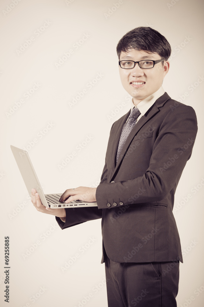 Asian business man using laptop computer isolated on white backg Asian business man using laptop computer isolated on white backg
