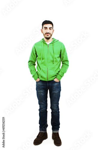 Young man standing with hands in pockets