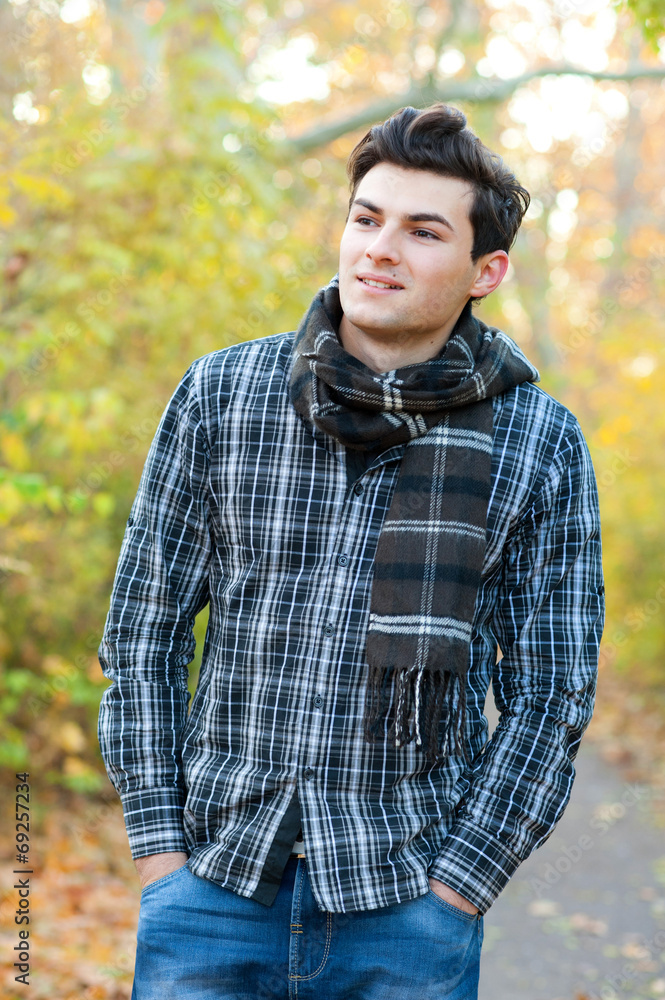 Smiling man hiking in autumn park. Smiling man hiking in autumn park.