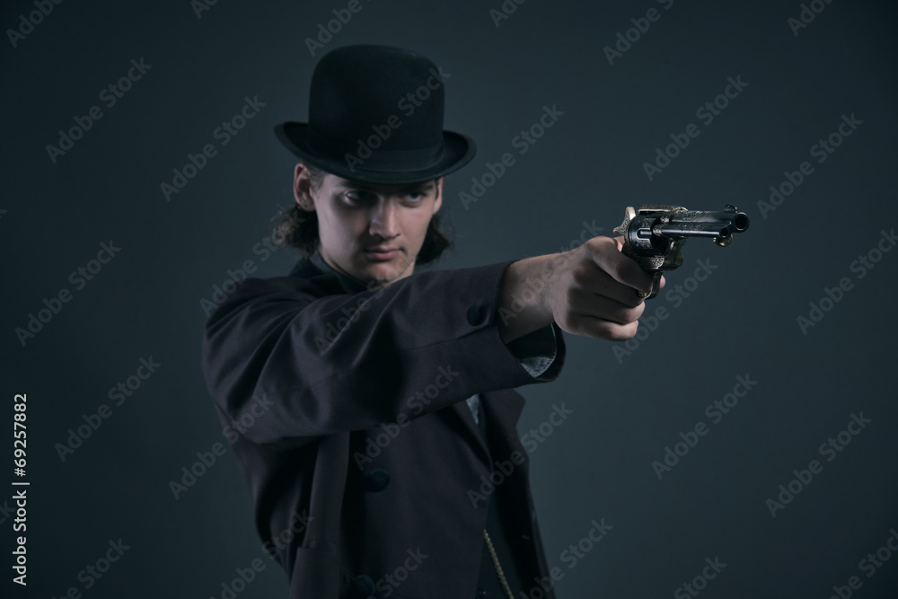 Shooting western 1900 fashion man with brown hair and hat. Studi Shooting western 1900 fashion man with brown hair and hat. Studi